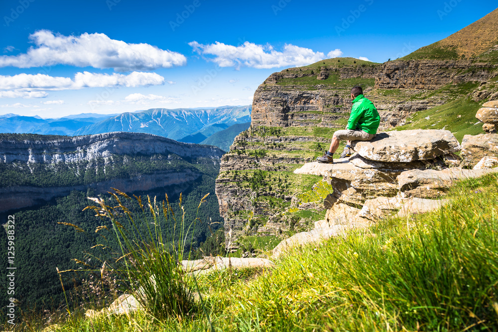 Man hiker on a top of a mountain