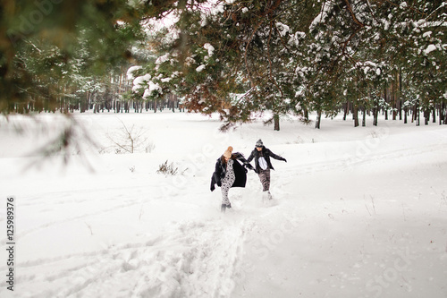 Winter weekend. Happy couple running in the winter forest © Wedding photography