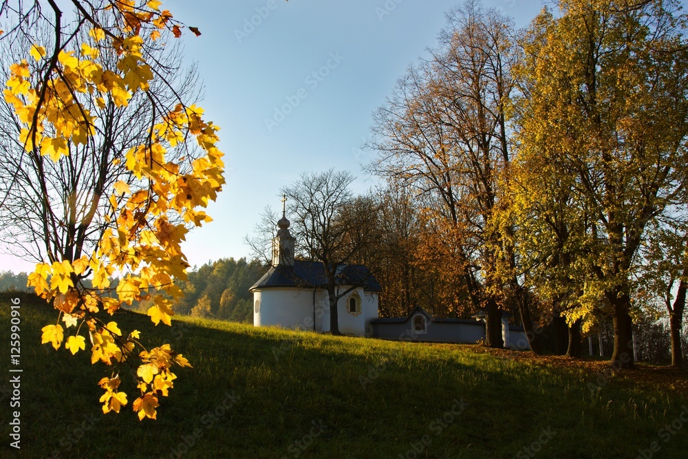 Calvary in Slovakia. Christian church in Banska Bystrica. Falling leafs in autumn landscape, Catholic chapel with cross symbol. Calvary in Slovakia. Christian church in Banska Bystrica. Falling leafs in autumn landscape, Catholic chapel with cross symbol.