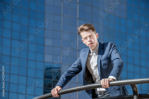 Successful business man over office background in the street