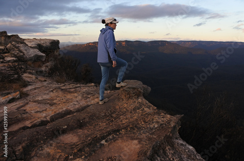Woman looks at the landscape from Lincoln Rock Lookout at sunris