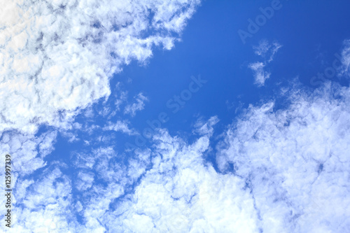 Blue sky background with white clouds. The vast blue sky and clouds sky on sunny day. White fluffy clouds in the blue sky.