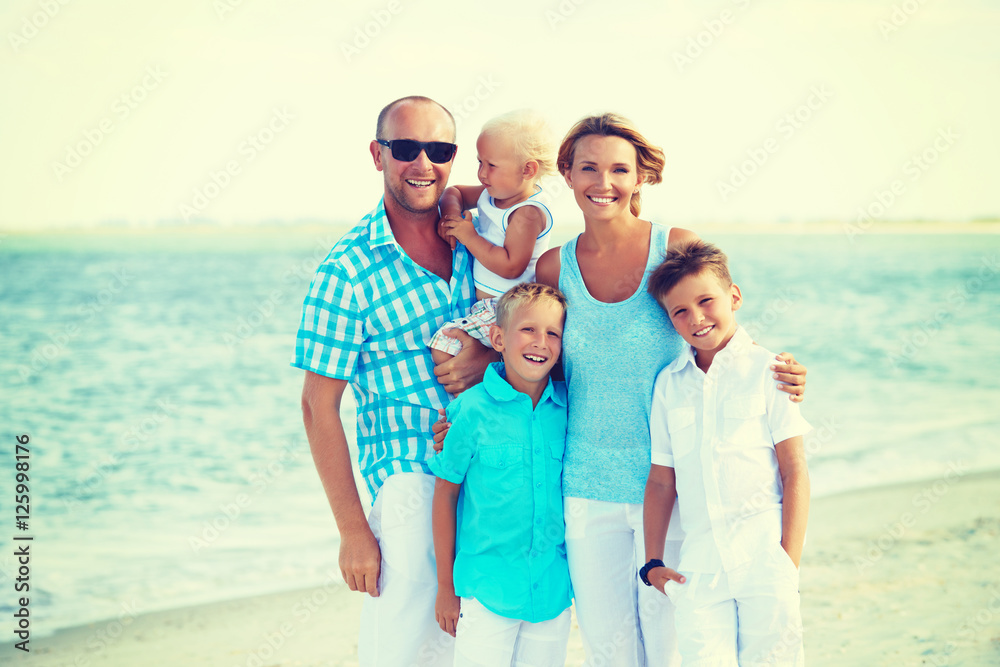 Happy smiling family with children standing.