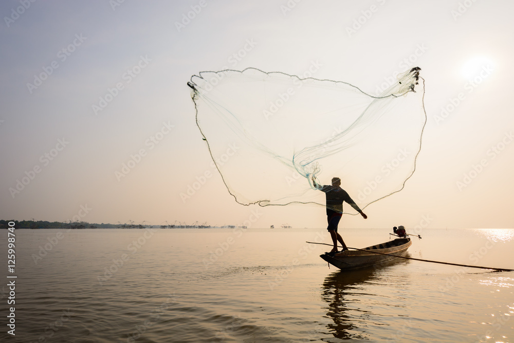 A man catching fish by used fishnet at Pakpra village, Phatthalung, Thailand