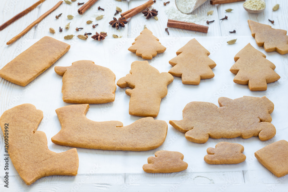 Baked gingerbread cookies for christmas 3D composition on wooden table, spices on background, horizontal Baked gingerbread cookies for christmas 3D composition on wooden table, spices on background, horizontal