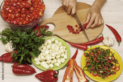 Adjika fresh grated red pepper and chili. . Red hot chilli pepper and ingredients for sauce.  photo