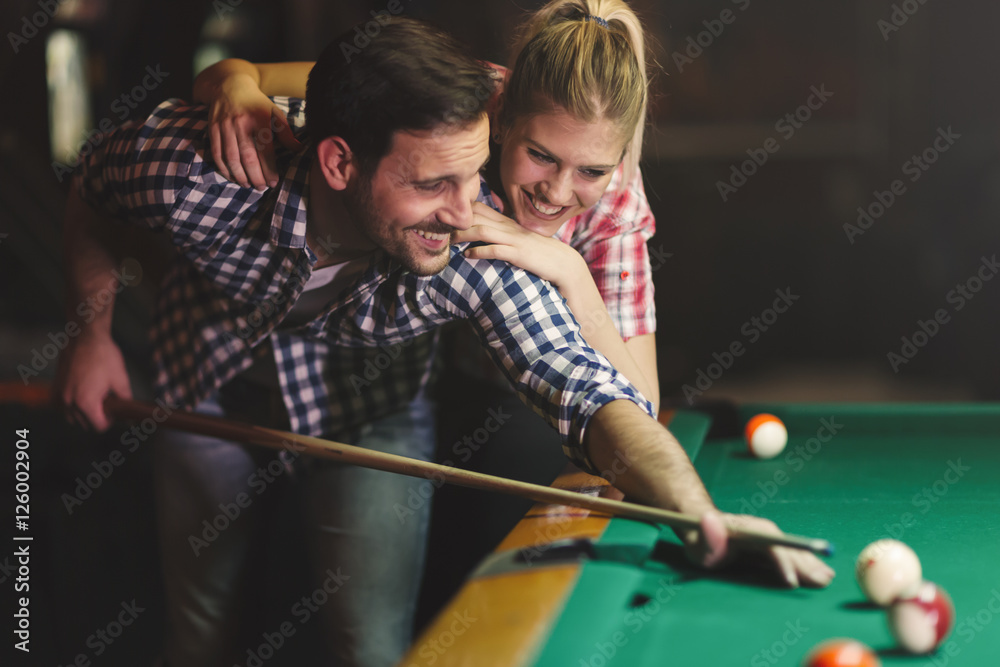 Fototapeta premium Couple playing billiards together