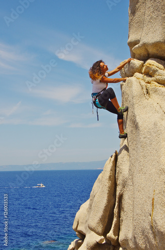 Attractive young woman climbing