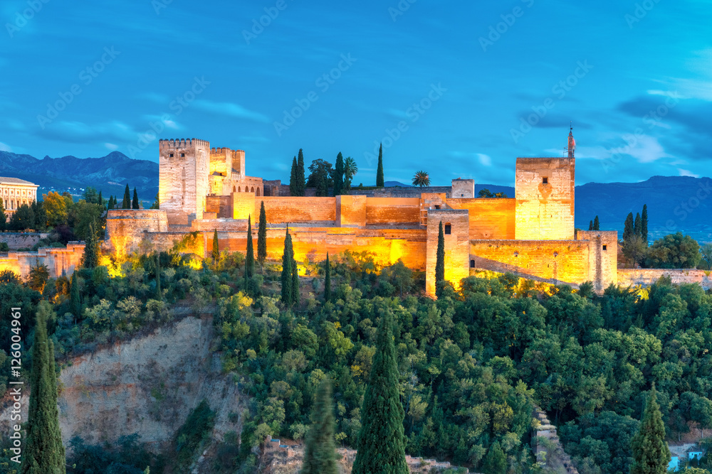 Moorish fortress Alcazaba, citadel of Alhambra, during evening blue hour in Granada, Andalusia, Spain