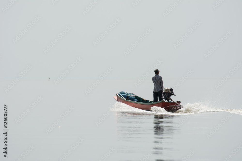 NOV 5,2016 : The fisherman sailing at Bangpakong river in Chachengsao Provice east of Thailand.(on white background)