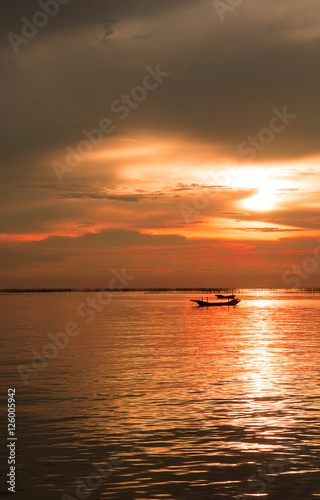 Sea evening sun at sunset. red sunlight sea and the boat