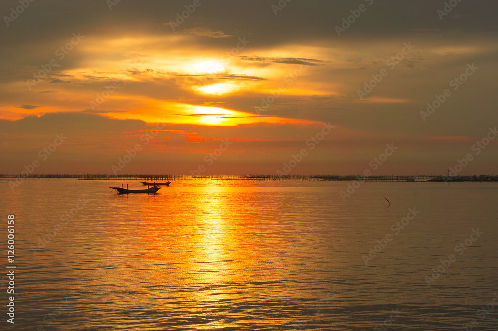 Sea evening sun at sunset. red sunlight sea and the boat
