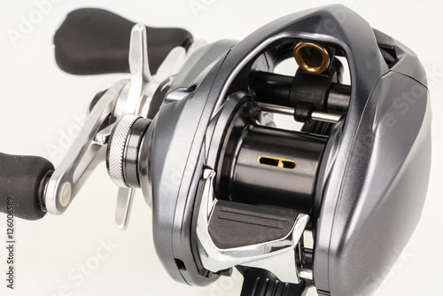 Multiplier fishing reel on white background.