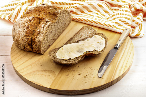 irish soda bread with creamy irish butter on a wooden plate