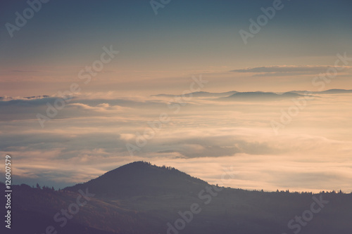 Foggy mountains at sunrise. © vovik_mar