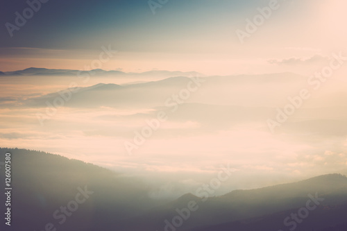 Foggy mountains at sunrise. © vovik_mar