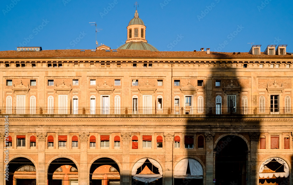 D'Accursio Tower projecting its shadow on renaissance building in Bologna,Italy.