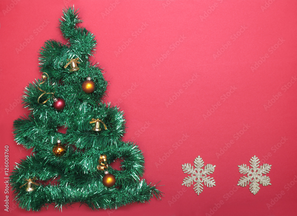 Closeup of Christmas tree on red background