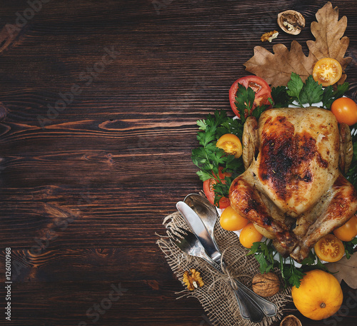 Holiday dinner on the table. Chicken and vegetables and tablewar photo