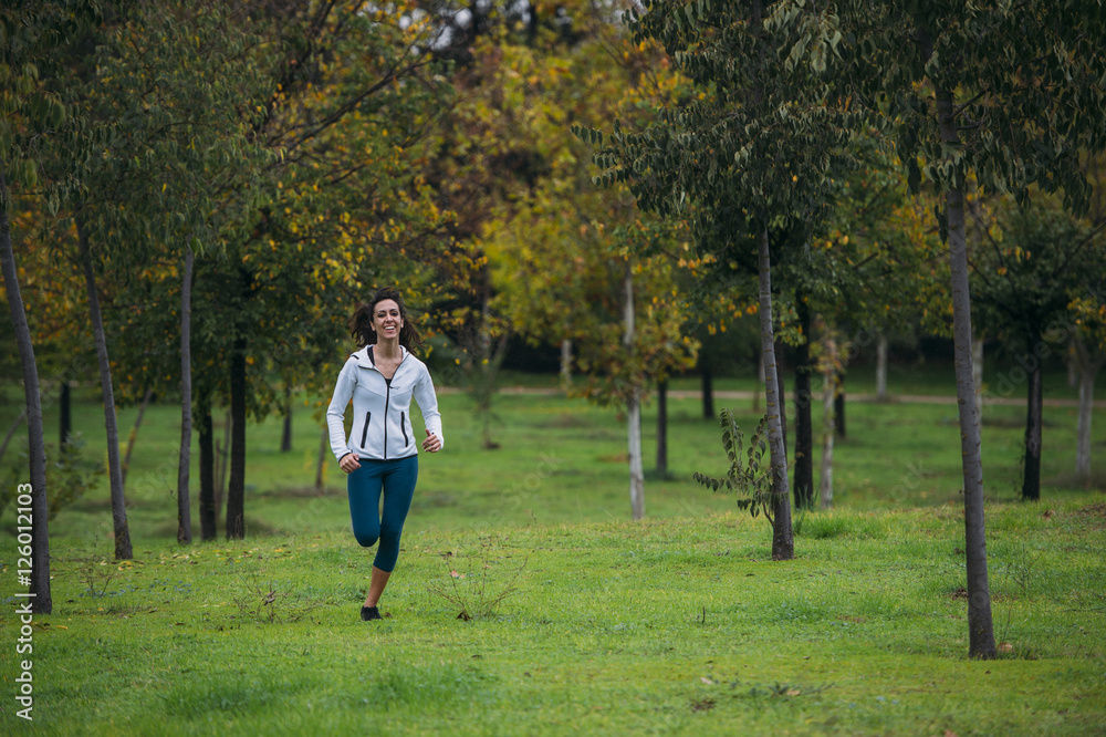 woman practicing running in the park woman practicing running in the park