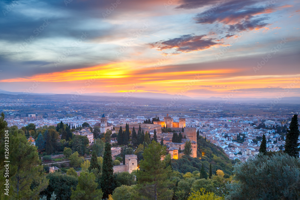 Palace and fortress complex Alhambra with Iglesia de Santa Maria, Palacios Nazaries and Alcazaba during sunset in Granada, Andalusia, Spain