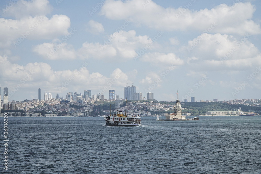 Ferry passes The Maiden's Tower on sea in Istanbul, Turkey