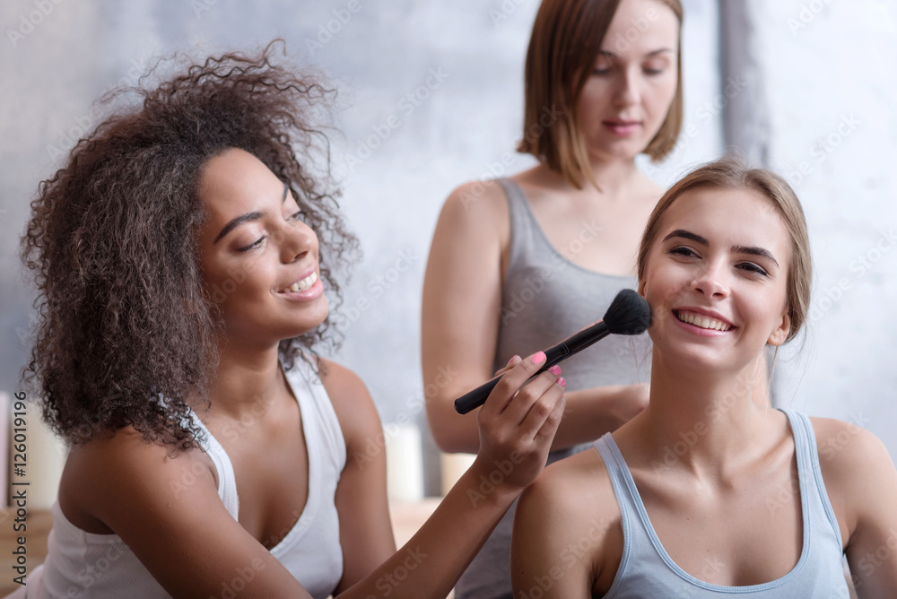 Smiling friends getting ready in the bedroom at home Smiling friends getting ready in the bedroom at home