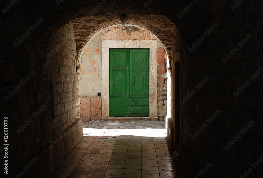 Underpass in Kotor (Montenegro, view to a green door