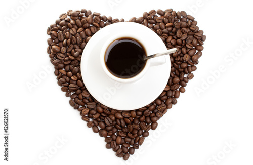 white cup of coffee on beans as a heart