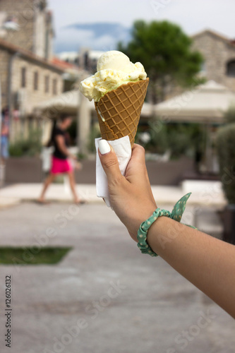 Ice cream in hand. Girl holds ice-cream in her hand in the old b