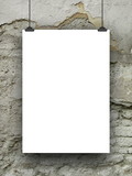 Single blank frame hanged by clips against cracked and scratched wall background