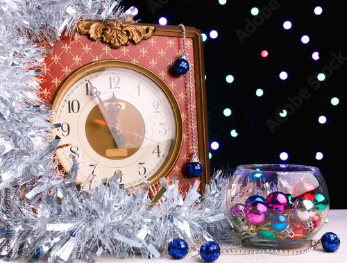 Vintage watch on a background garlands of light bulbs