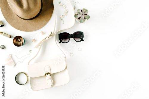 Flat lay trendy creative feminine accessories arrangement. Purse  hat  sunglasses  female accessories. Top view