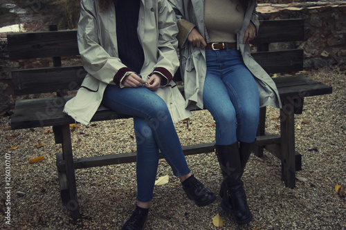 Dos mujeres sentadas en un banco un día de otoño