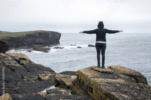 Girl looking Orkney coastline Yesnaby cliff landscape photo