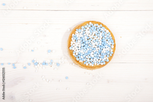 Traditional Dutch birth celebration biscuit with blue muisjes on wooden background photo