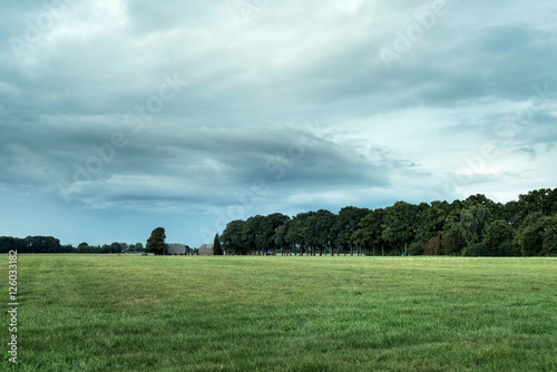 Old dutch farm in rural landscape with cloudy sky. Geesteren. Ac