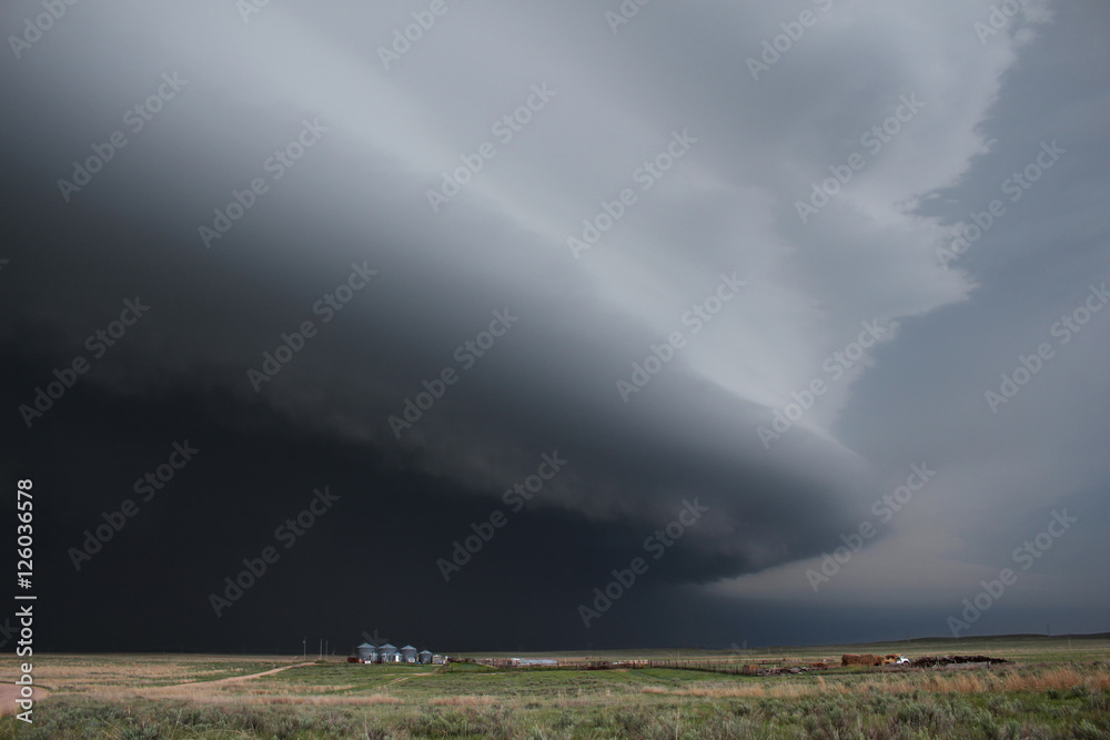 A massive dark supercell on the high plains of eastern Colorado.