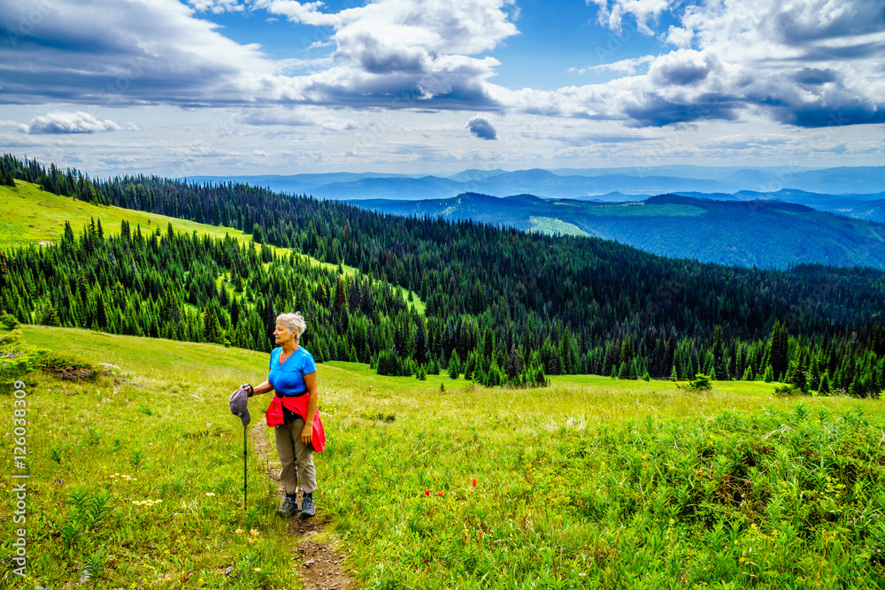 Senior Woman enjoying the View from Tod Mountain in the Shuswap Highlands of British Columbia, Canada