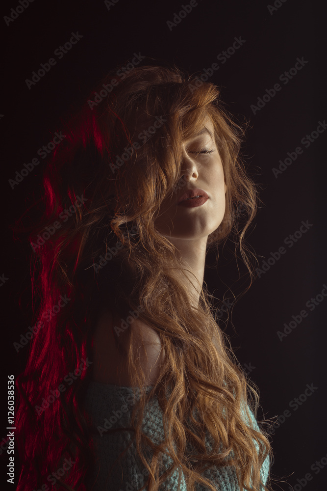 Magnificent young model in the shadows with red light