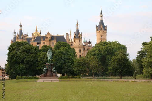 Castle garden and Statue Frederick Francis II with view to Schwerin Castle, Mecklenburg Germany 