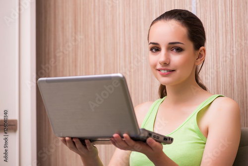 Young woman working at laptop at home © Elnur