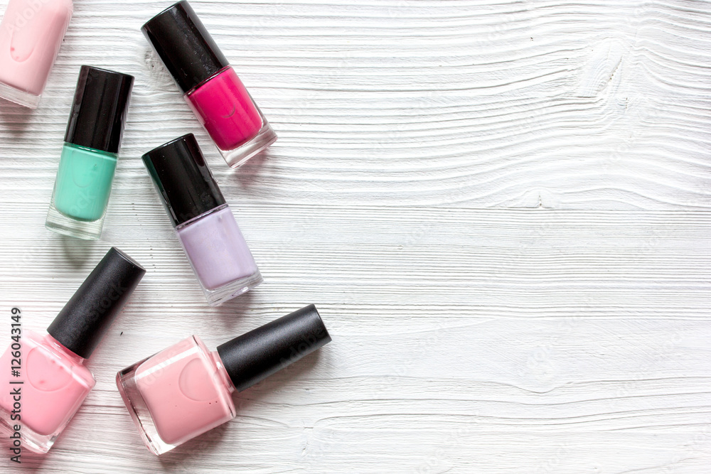 group of nail polish on wooden background top view
