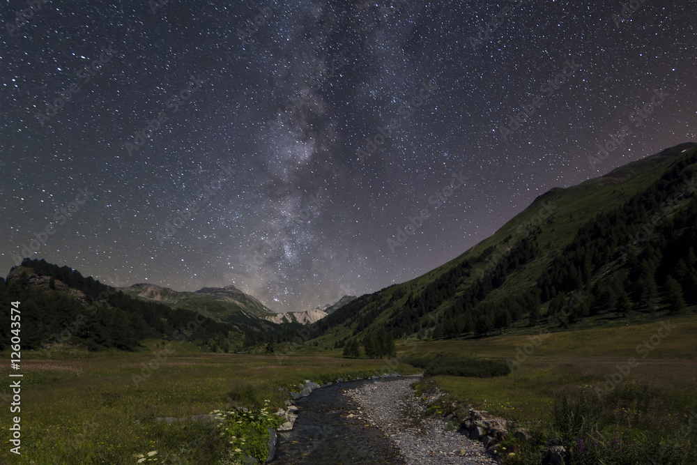 Milky way landscape over field and river landscape