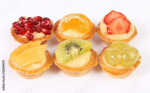pastry tartlets with fresh fruit isolated on white background