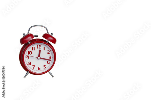 Red retro alarm clock on white background