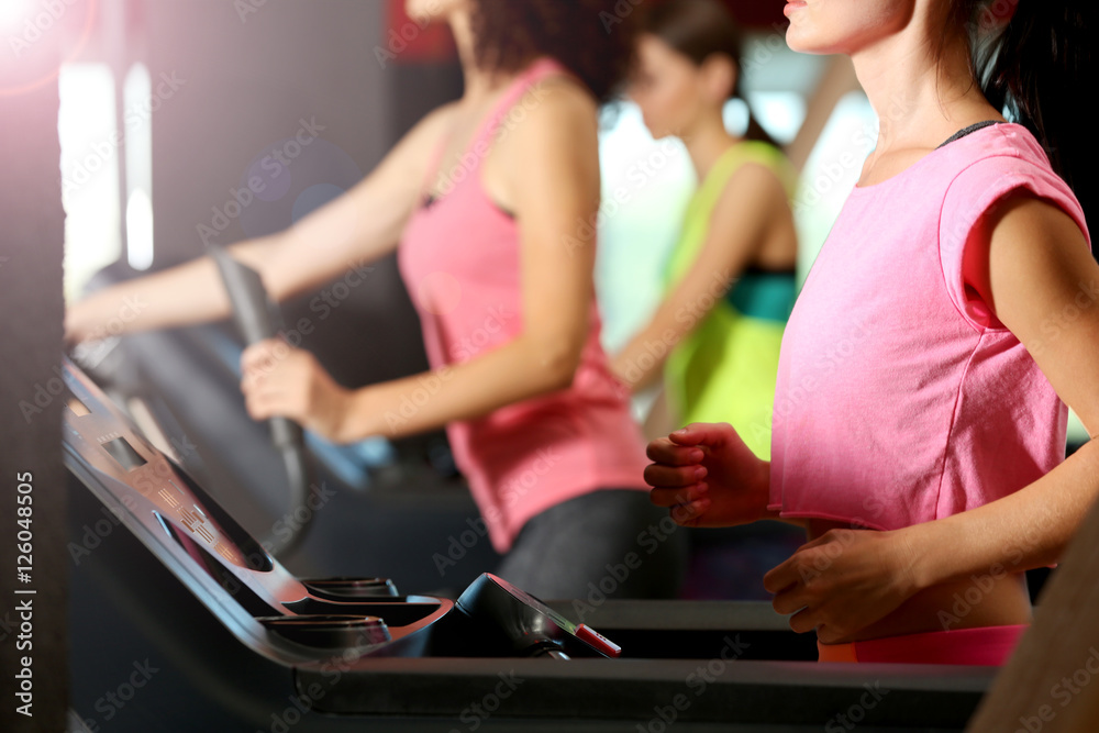 People training on exercise bike in gym People training on exercise bike in gym