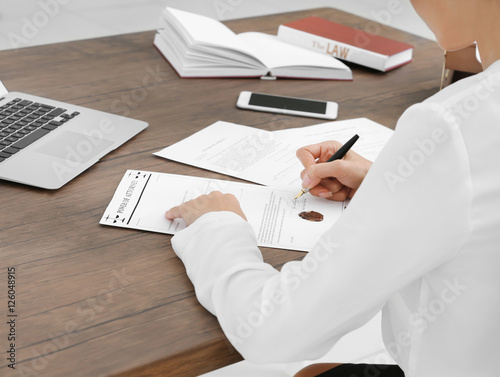 Female lawyer signing docum...