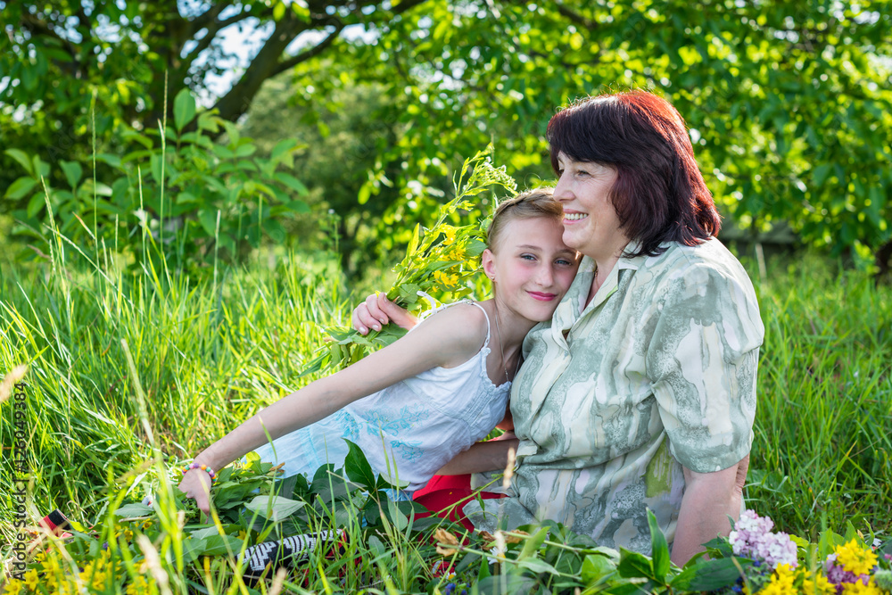 Granny with her granddaughter in the garden Granny with her granddaughter in the garden