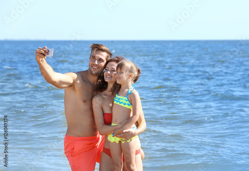Cheerful family taking self...